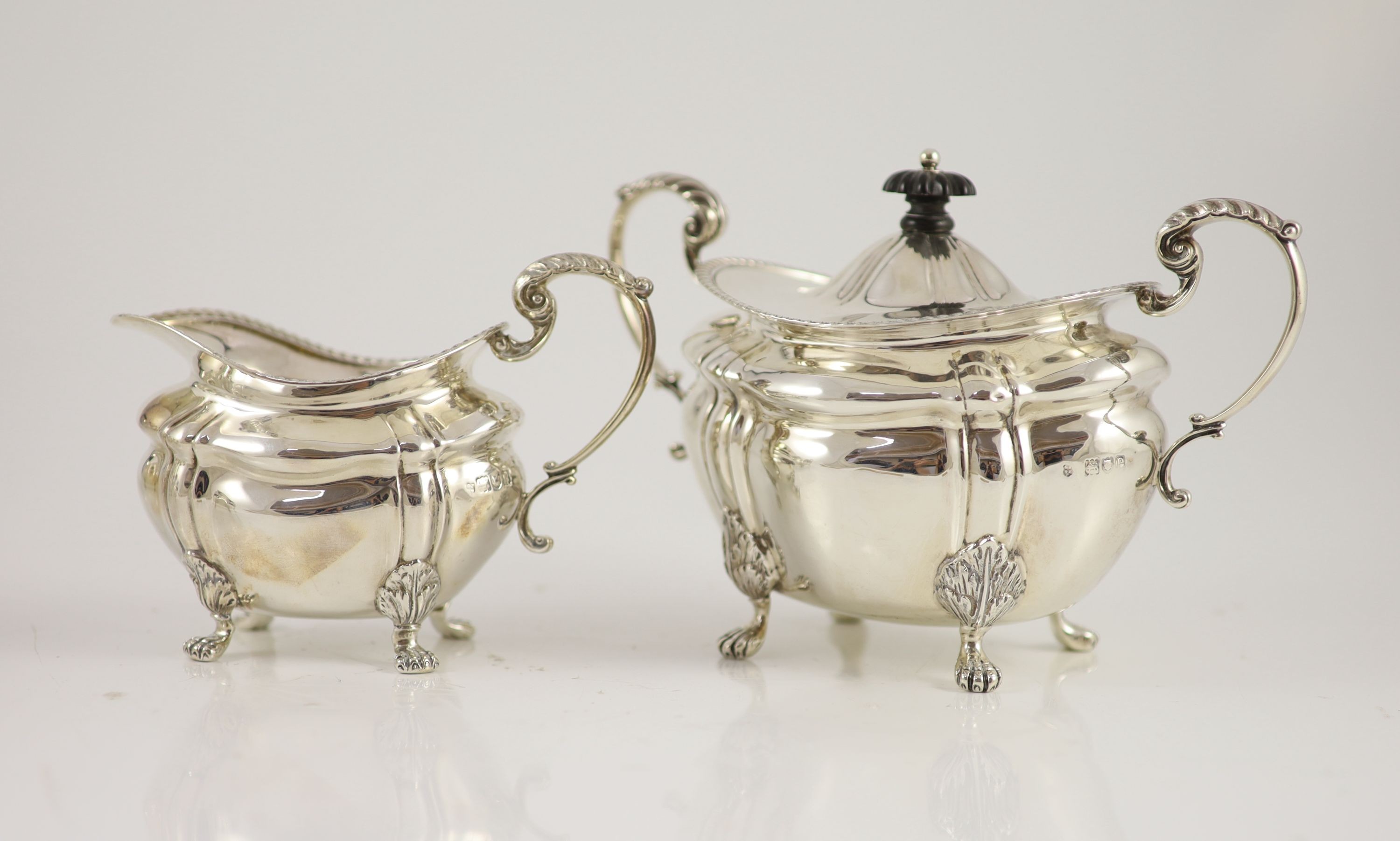 A late Victorian four-piece silver tea set comprising teapot, lidded bowl, twin handed sugar basin and jug with gilded bowls throughout, Josiah Williams & Co, London, 1900